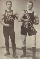 Сергей Елисеев и Георг Гакеншмидт — тяжелоатлеты и борцы, первые русские чемпионы мира; Елисеев получил золотую медаль ЧМ по тяжёлой атлетике (1899); Гакеншмидт выиграл ЧМ по борьбе в т/в (1901) и первый чемионат мира по рестлингу в тяжёлом весе (1905), крупный популяризатор и философ спорта