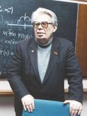 Николай Боголюбов — создал школу нелинейной механики и множество методов, понятий и теорий математической физики; один из авторов цепочки ББГКИ, трёхтриплетной кварковой модели и понятия цветного заряда